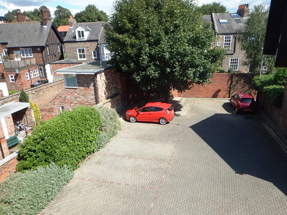 View from apartment our car in our parking space below Sycamore Tree