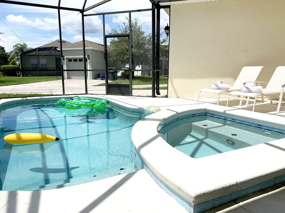 Pool area showing spa and sun loungers