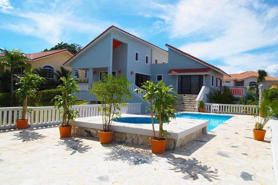 pool deck with a back view of the villa