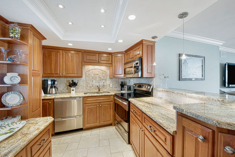 Fully equipped kitchen with custom cherry cabinets, exotic granite