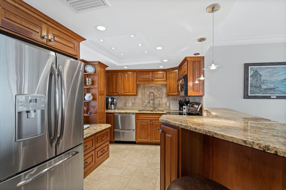Chef's kitchen with bar counter facing the waterview