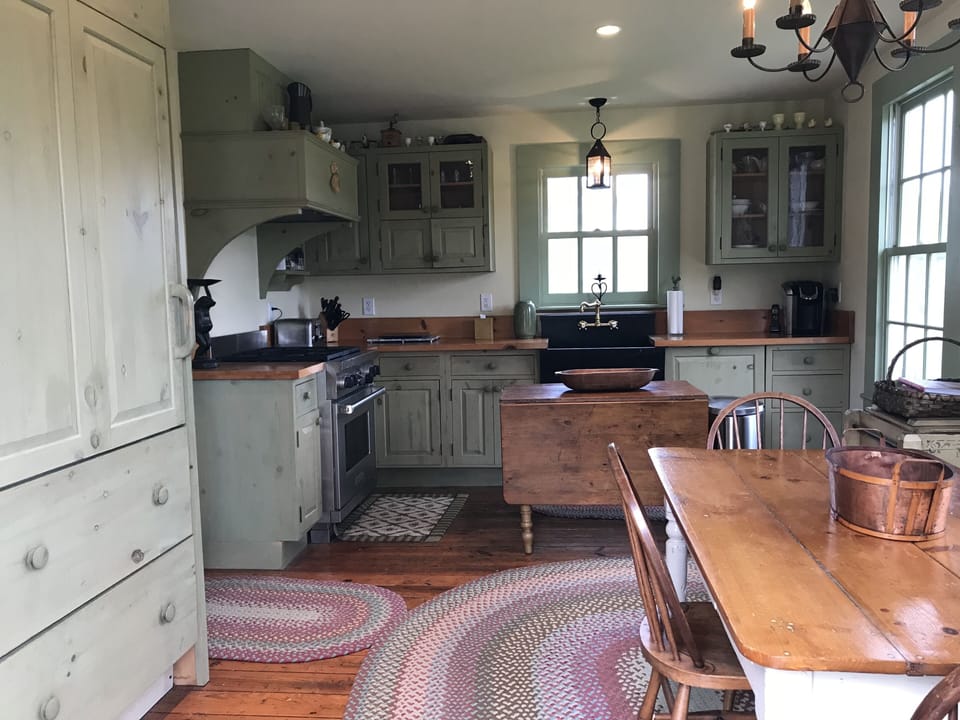 hiden refrigerator on left with Wolf stove and custom limestone sink