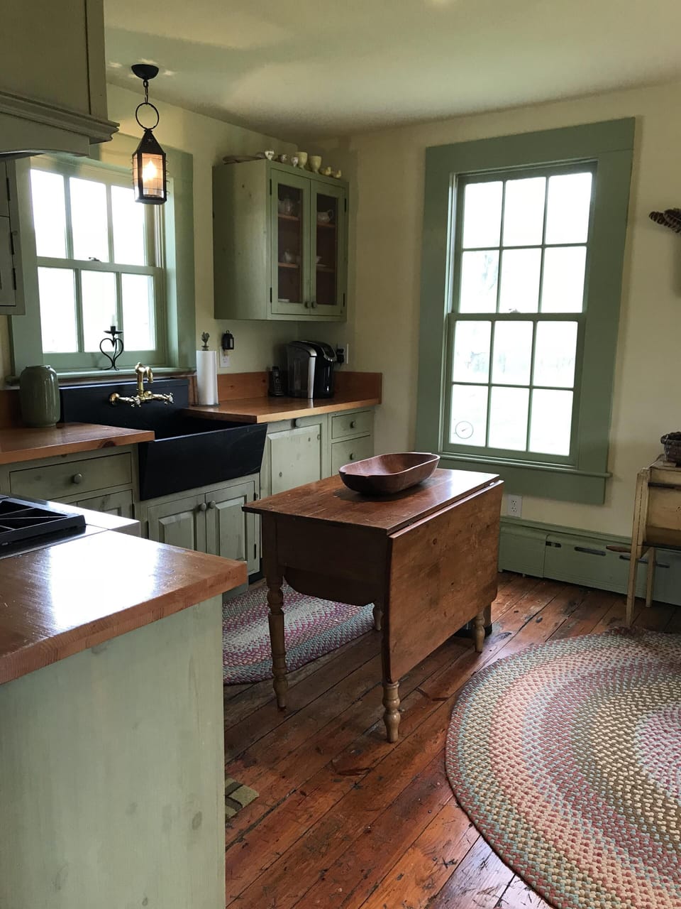 Kitchen entry from dining room with antique bakers table 
