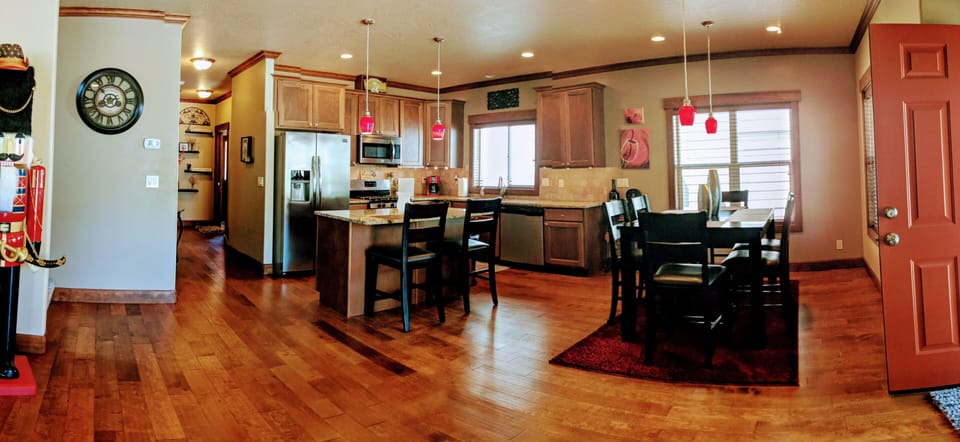 Open, spacious kitchen with counter seating & table that expands to seat 8