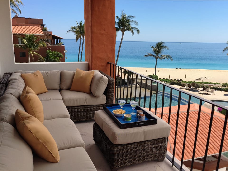 Patio overlooking the pool and the beach beyond 