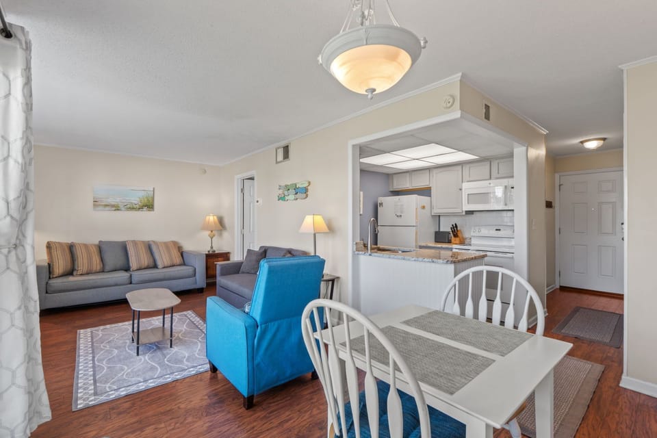Unwind in this bright, open living space where comfort meets convenience. Your fully equipped kitchen overlooks cozy seating perfect for relaxing after a day of exploring.
