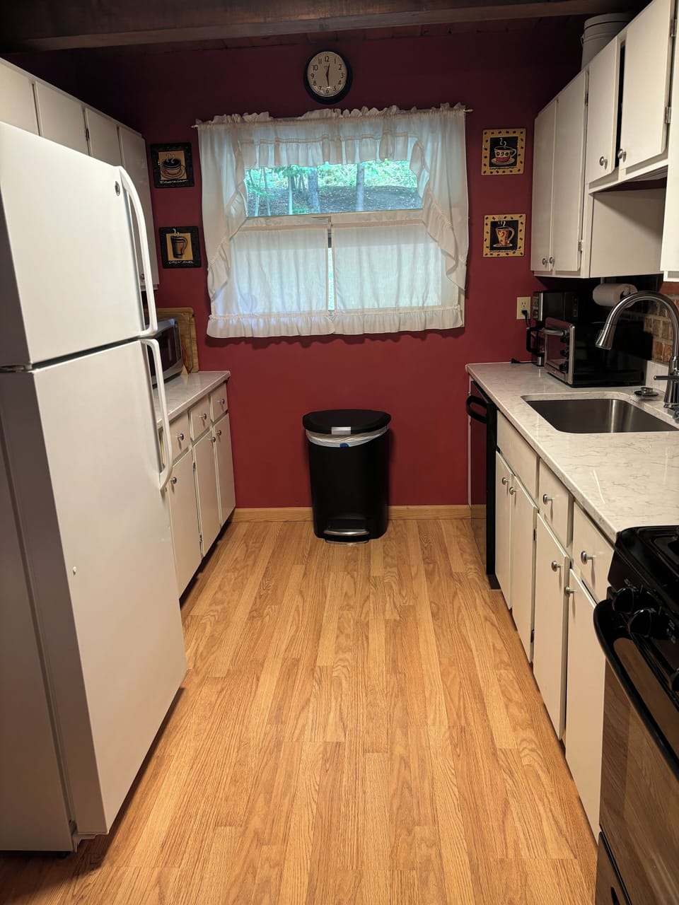 Kitchen.  Refrigerator and microwave at end of counter