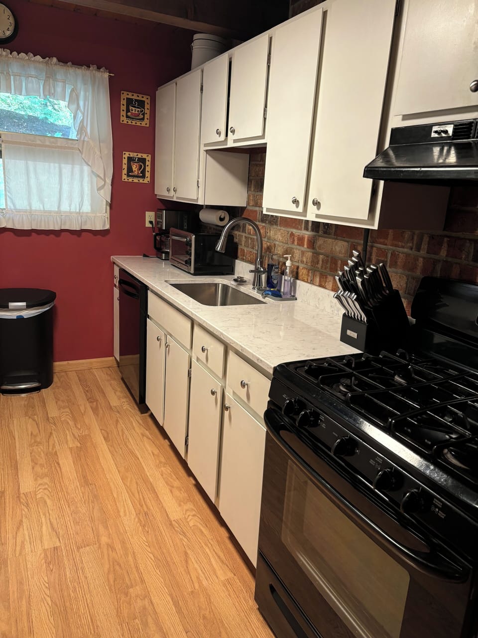 Kitchen. Stove, toaster oven, and coffee pot