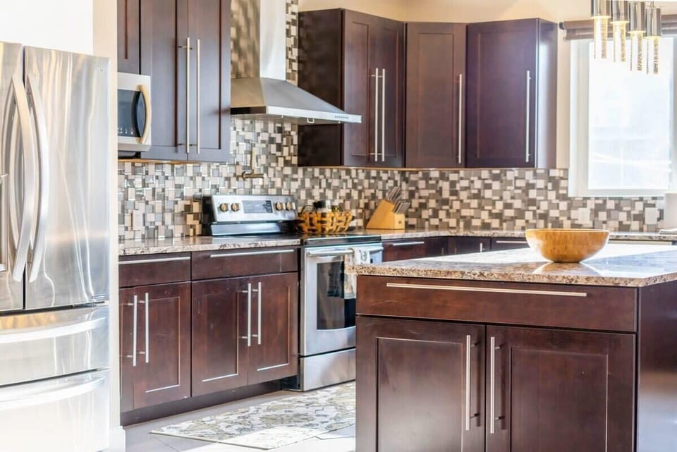 Granite countertops are paired with contemporary cooking appliances.