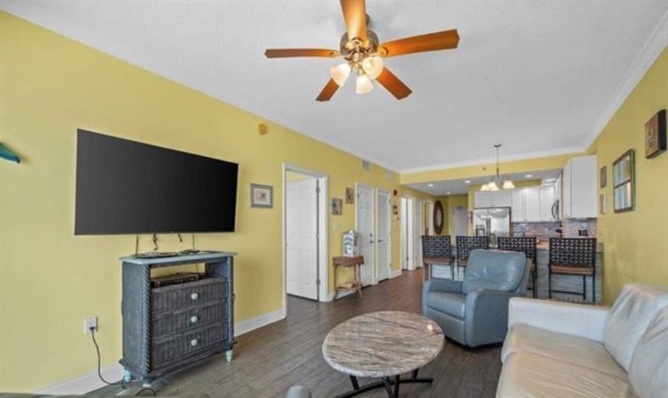 Living room with awesome view, leather queen sleeper sofa with memory foam mattress, 2 leather rocker/swivel recliners, 55" SMART TV & balcony access