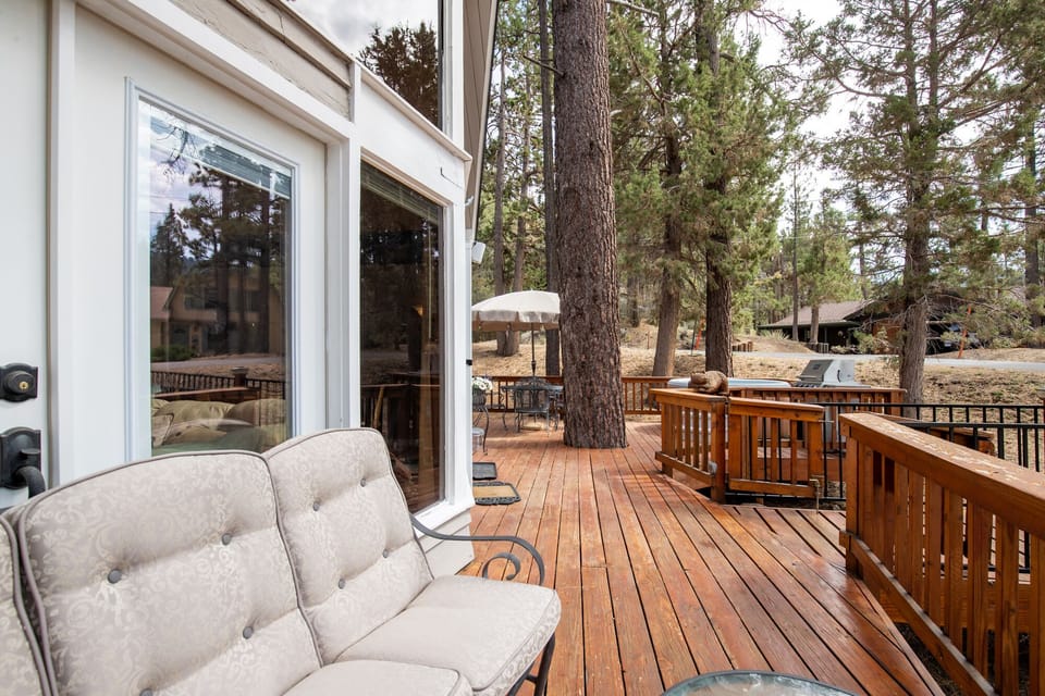 Private outdoor hot tub, surrounded by tall pines, perfect for relaxing under the trees after a day of adventure—enjoy peaceful forest views, fresh air, and a truly rejuvenating stay.