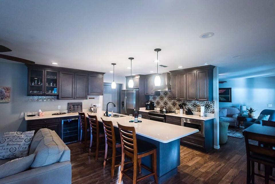 Open design kitchen with plenty of prep space; bar and wine fridge 