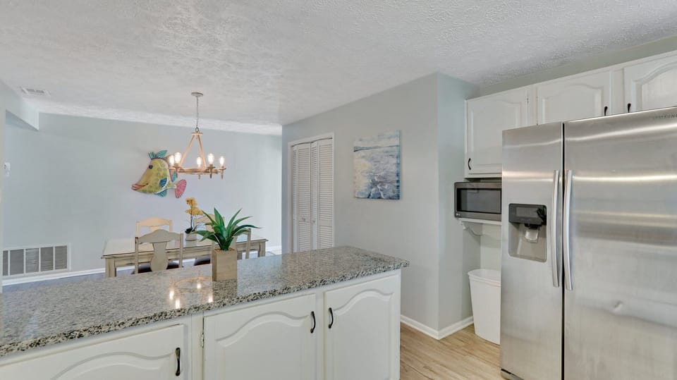 Plenty of prep space! The microwave is located by the fridge. 