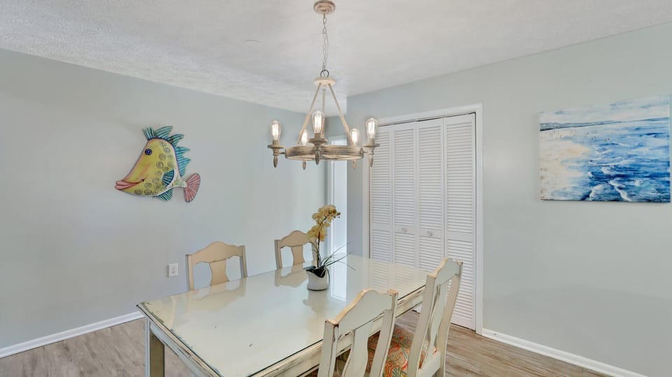 A spacious dining room with a utility closet with basic supplies.