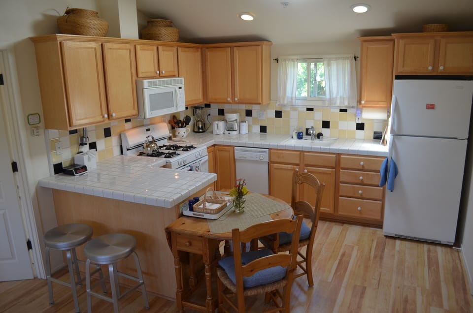 Inviting and open, skylights flood the room. Drop leaf table opens up for dining