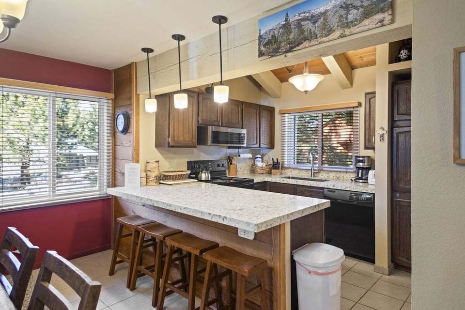 Kitchen with a large bar with additional seating