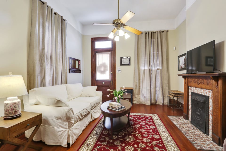 Living room with queen sofa sleeper and large flat screen TV.