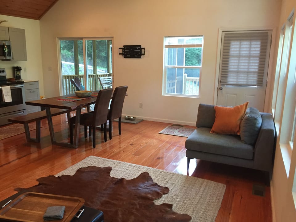 View front door and sliding glass door to newly enlarged screened in porch area.