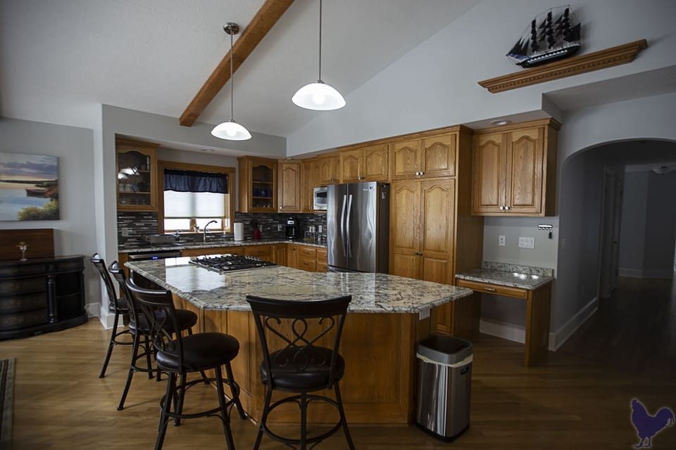 Kitchen offers seating for four at bar and new appliances