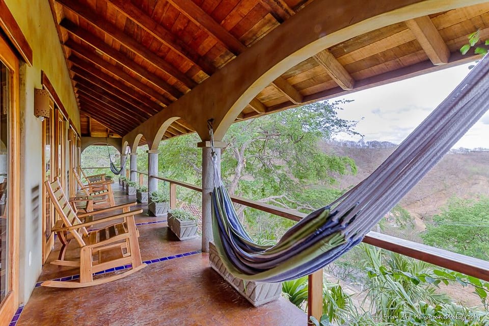 Front veranda with two hammocks and four rocking chairs.
