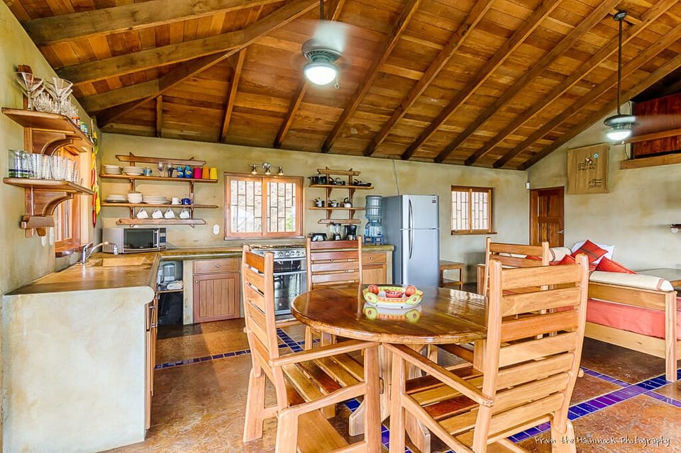 Kitchen with fridge, gas range, microwave, small appliances, plenty of gadgets.