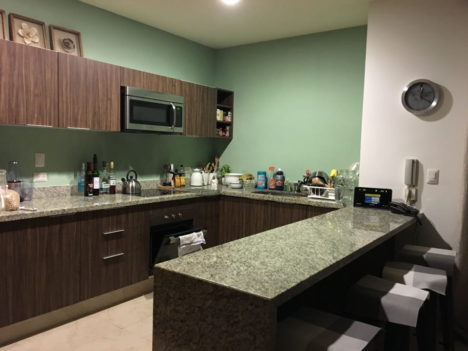 Open concept kitchen with marble waterfall countertop and fully stocked