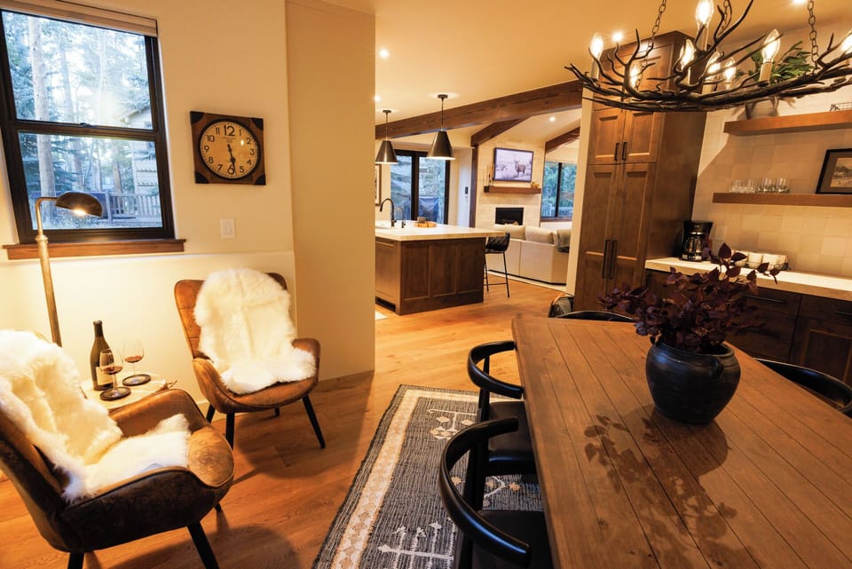 Dining area connected to kitchen and living room. Seating area and fireplace.