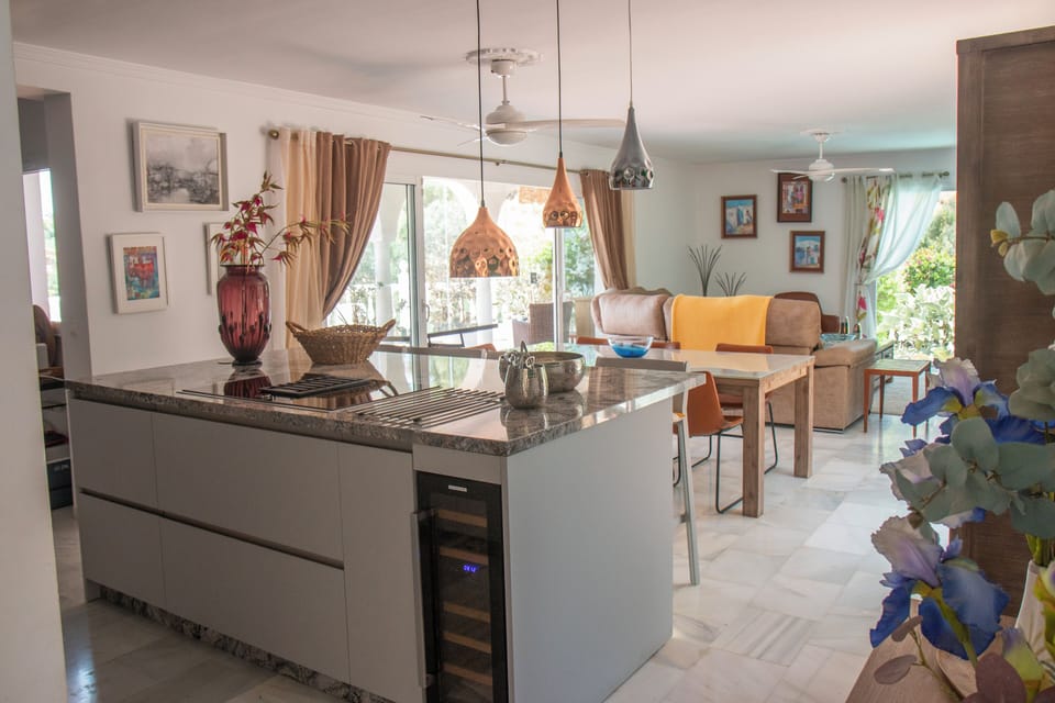 Leading from the entrance hallway, breakfast bar, dining, front terrace & lounge