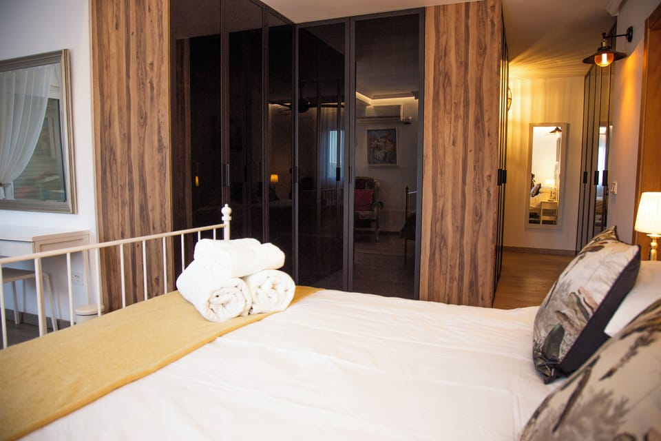 Rainforest Rest luxury wardrobe flanked with rustic timbers & warm ambient glow.