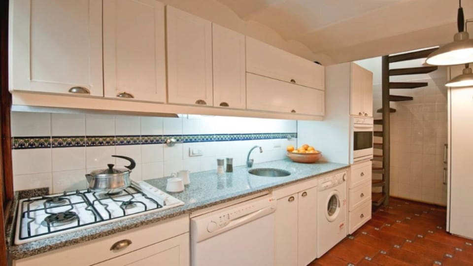 Large, modern, fully equipped gally kitchen.  Stars at rear lead to loft bedroom