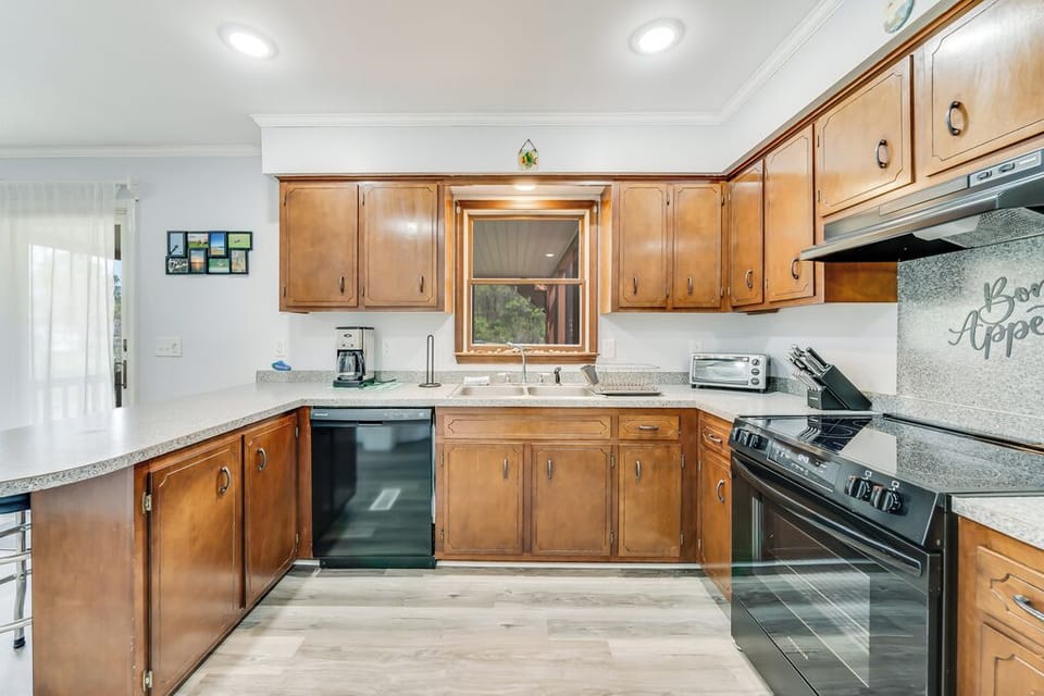 Kitchen opens to spacious Dining Area and Screened-in Porch.