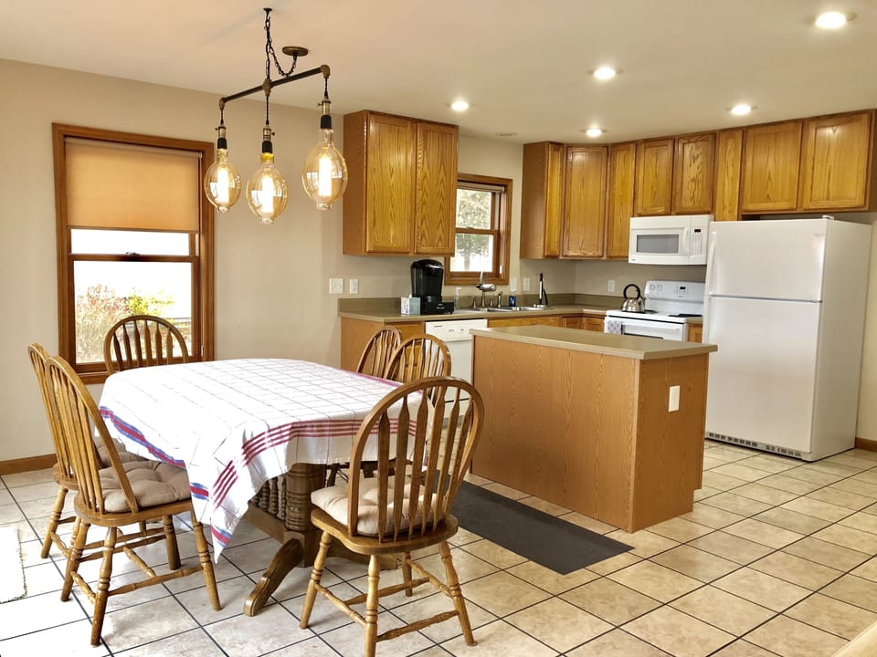Large kitchen table adjustable to 10 seatings.