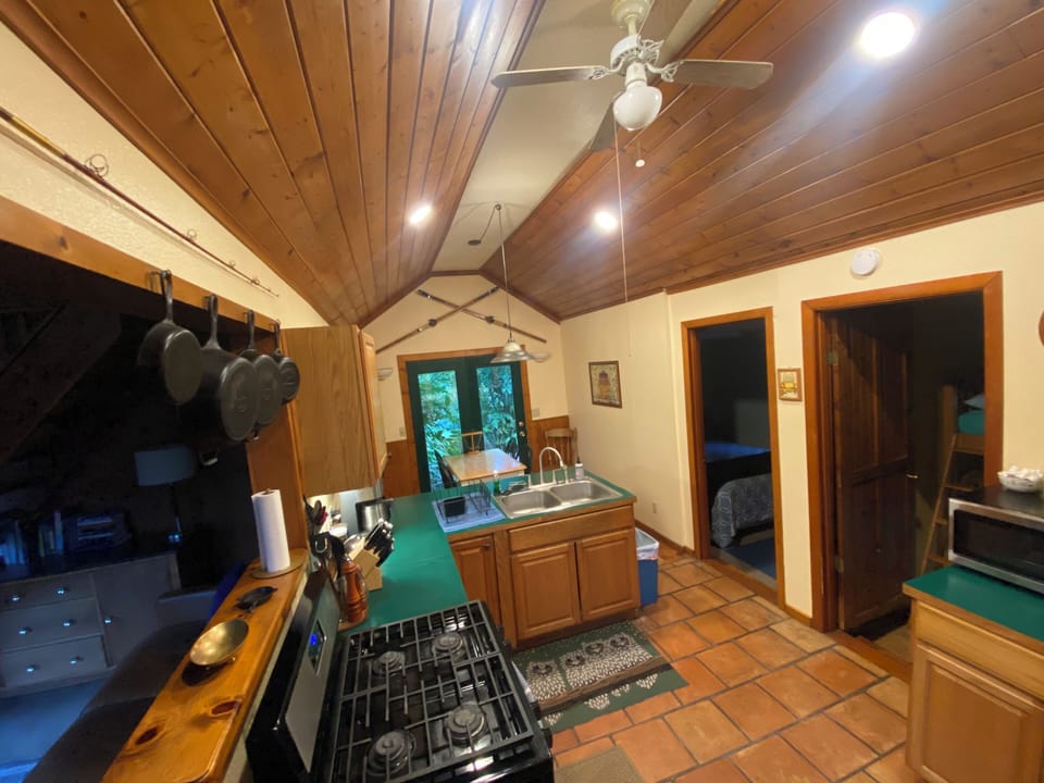 Full kitchen and dining area leads to deck and fire pit out back (8/2025).