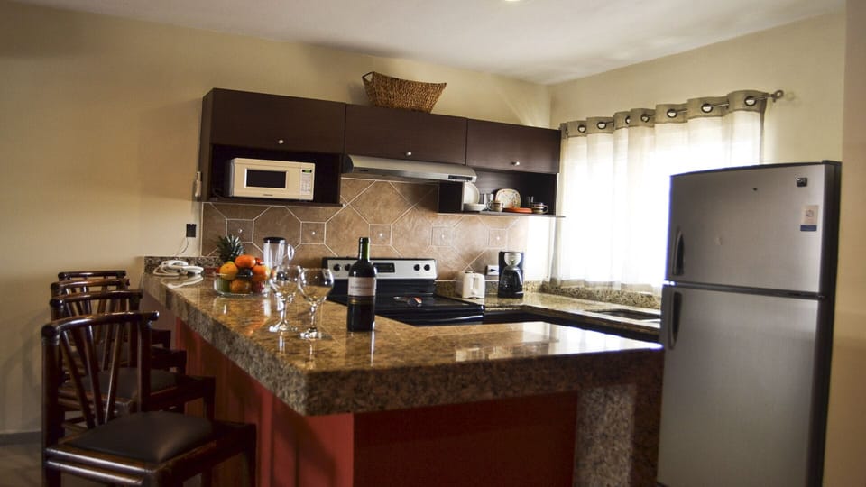 Fully-appointed kitchen and island seating area. 