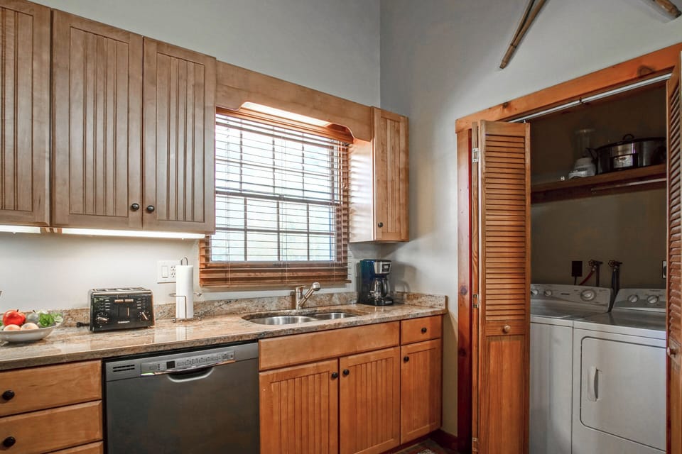 The washer and dryer are located inside the closet in the kitchen.