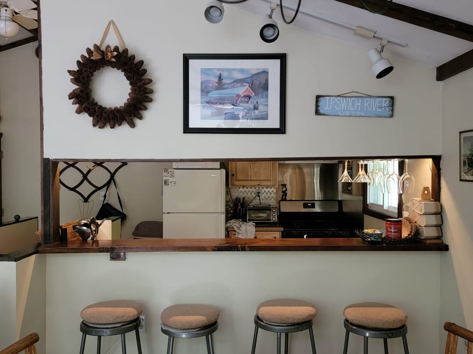 Bar seating. Kitchen pass through to dining area.