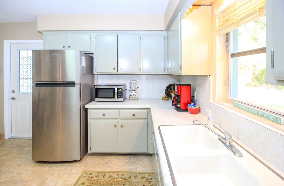 Large 1050's kitchen with newly painted cabinets, new fridge and microwave.