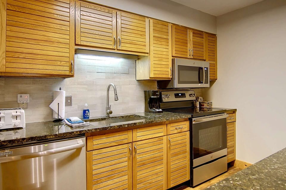 Stunning updated kitchen with stainless steel appliances and granite counter tops.