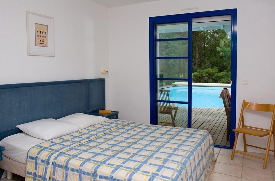 Drift to sleep in the comfortable Double bed after a wonderful day outside. (Patio Access May Vary)