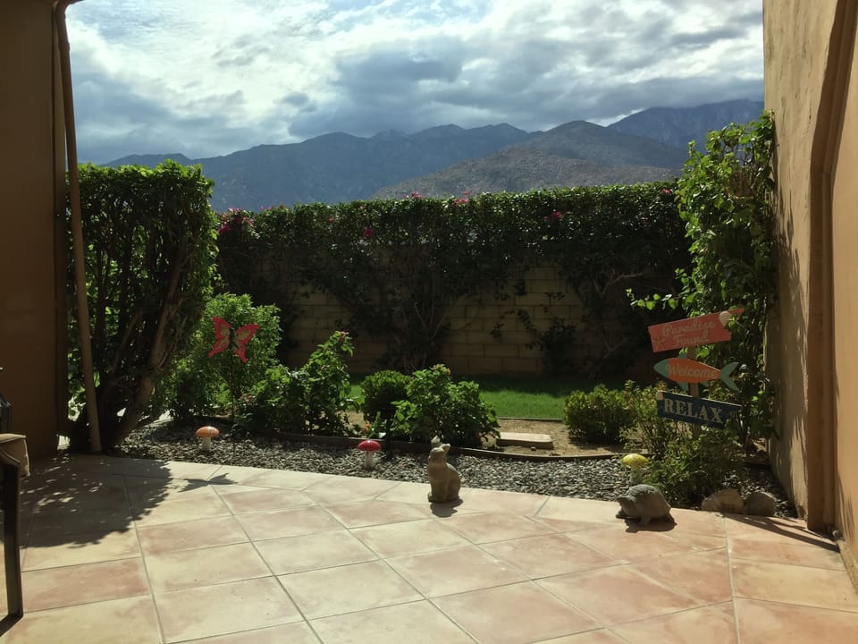 Private patio including bougainvillea.  A Roll down shade recently added. 