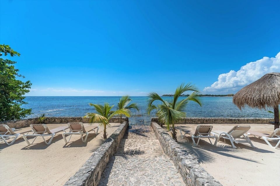Loungers and shade palapas for guest use - La Iguana condo 4, 1 bedroom Akumal vacation rental Akumal Mexico vacation rental