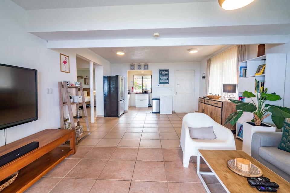 View of the fully equipped kitchen from the living room (with air conditioning)