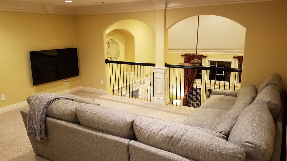 Upstairs common area, with 65" television and space for one or two roll-away bed