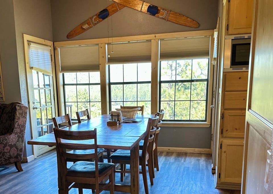 Main Floor: Dining Room. Doors on both sides to BBQ deck and Kitchen Deck.