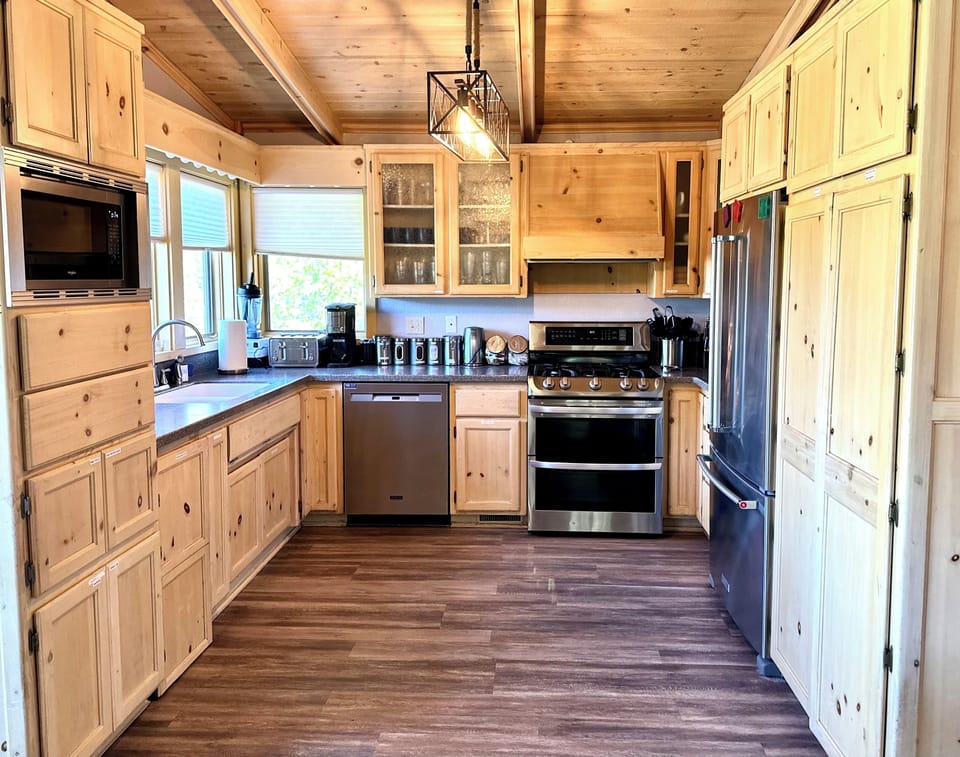 Main Floor: Kitchen with all new appliances to cook for large guest bookings. 
