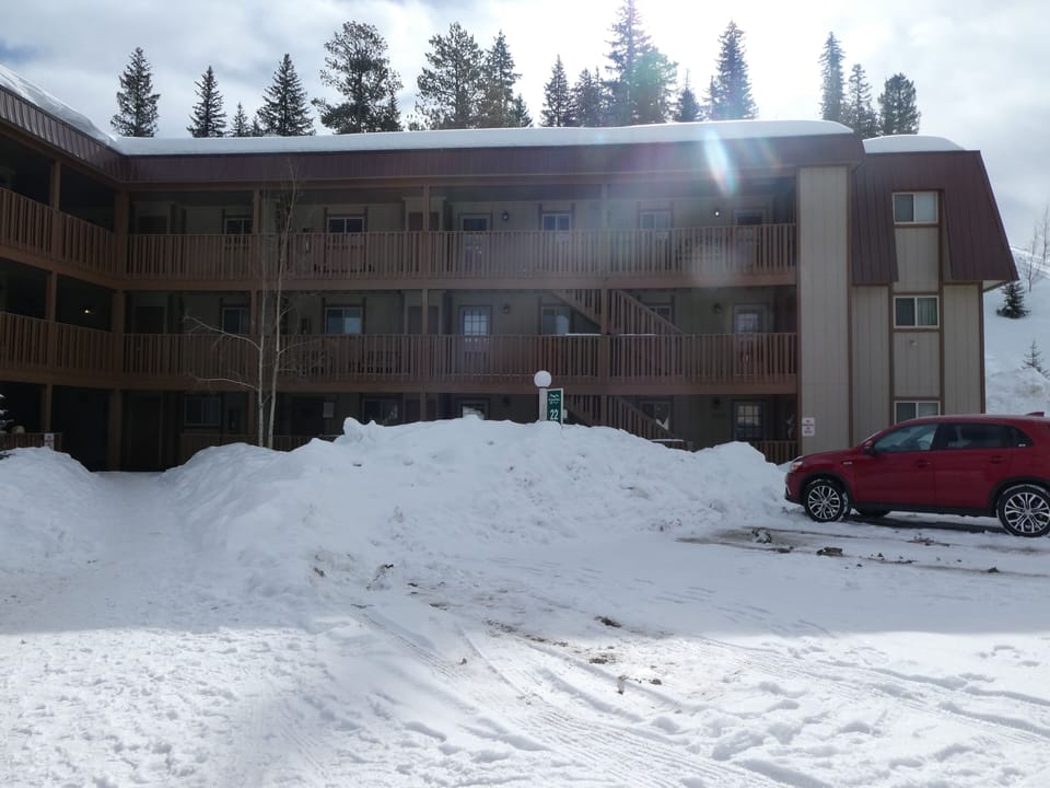 Outside of the building, parking and bus stop out front. 
