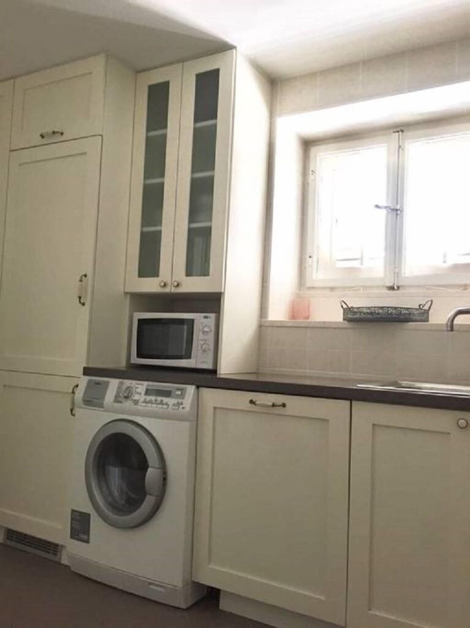 Built-in dishwasher and refrigerator, washing machine w dryer, microwave oven.