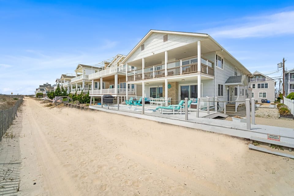 Wake up steps from the sand in this dreamy beachfront home with ocean views from every level.