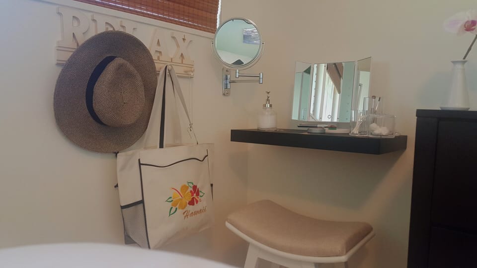 Bedroom vanity area with 3-way lighted mirror and magnifying wall mirror.