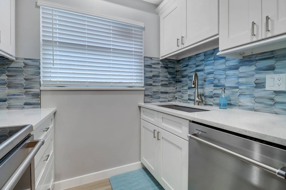 Plenty of new quartz counter space, large crushed granite sink, full sized dishwasher, beautiful new cabinetry & backsplash.
